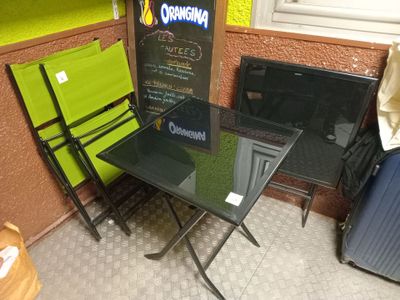 a table and chairs in a room with a sign on the wall