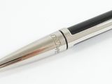 a pen that is sitting on a white surface