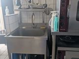 a kitchen with a sink and a microwave in it