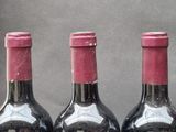 three bottles of wine that are sitting on a table