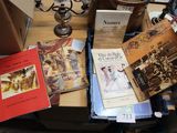 many books on a table with a candelab and a candelab