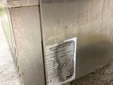 a silver refrigerator that has a sticker on the side of it