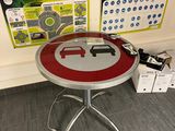 a table with a red and white sign on it