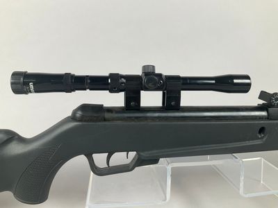 a close up of a rifle with a scope on it