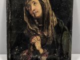 an old painting of a woman holding a rosary on a white surface