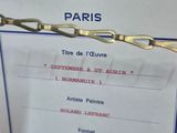 a sign with a chain attached to it that says galerie france art paris