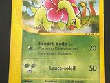a pokemon card with a picture of a dinosaur on it