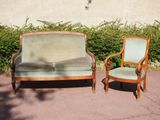 two chairs and a couch in the middle of the street