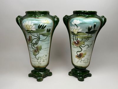 pair of green vases with flowers and leaves painted on them