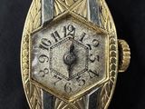 an image of a gold watch with a black strap