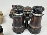 an old pair of binoculars sitting on top of a white table