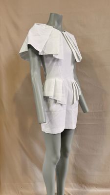 a mannequin wearing a white dress with ruffles on it