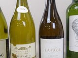 several bottles of wine are lined up on a table