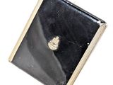 a small black box with a gold heart on it