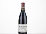 a bottle of red wine sitting on top of a table