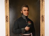 portrait of a man in a military uniform holding a medal
