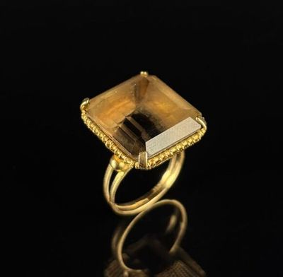 an image of a gold ring with a square cut citrine stone