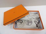 orange box containing a pair of glasses and a pair of socks
