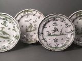 six green and white plates with birds and flowers on them