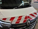 a white van with red and white stripes parked in a garage