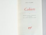 an open book with a red lettering on it sitting on a table