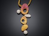 a gold necklace with pink and white stones on a black background