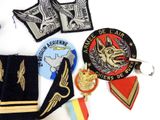 a lot of military patches and badges on a white surface