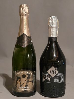 two bottles of champagne sitting next to each other on a table