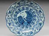 assiette bleue et blanche représentant un oiseau perché sur une branche d'arbre