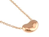 a gold heart shaped pendant on a gold chain