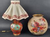 two vases and a lamp on a table with a lamp shade