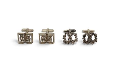 three pairs of silver cufflinks on a white background