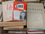 many books stacked on top of each other in a box