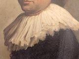 portrait of a man in a black and white dress with a white ruffled collar
