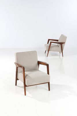 three chairs in a room with white walls and a white floor