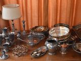 a table with a lot of silver items on it