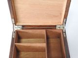 a wooden box with compartments inside of it on a white surface