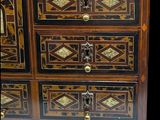 a small chest of drawers that has many drawers on it