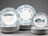 several plates with fish designs are stacked on top of each other