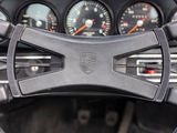 steering wheel of a sports car with gauges and speedometers