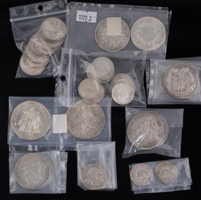 some silver coins are sitting in a bag on a black surface