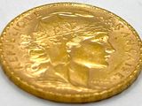 a close up of a gold coin with a woman ' s face on it