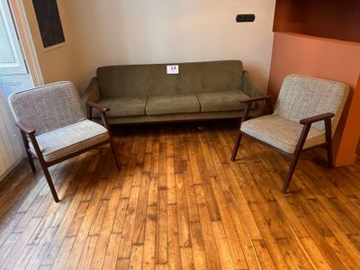 two chairs and a couch in the corner of a room