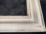 an old picture frame with a black and white picture in it