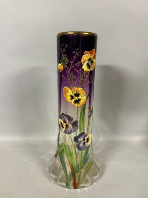 a vase with flowers painted on it sitting on a table