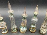 six glass candlesticks are lined up in a row on a table