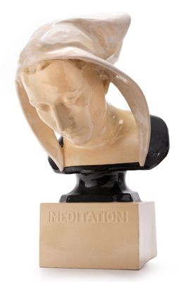 marble bust of a woman with a hat on top of it
