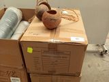 a cardboard box with a vase on top of it
