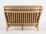 a close up of a wooden chair with a brown seat