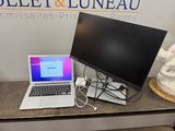 a laptop computer sitting on a desk with a monitor on it